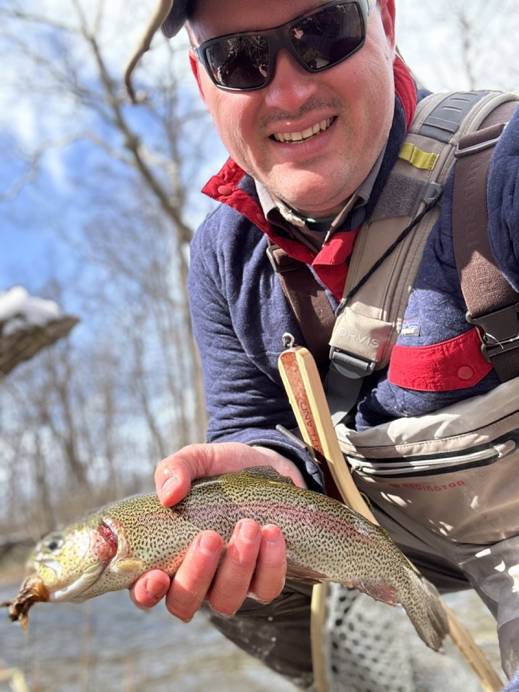 Close-up of a rainbow trout held streamside